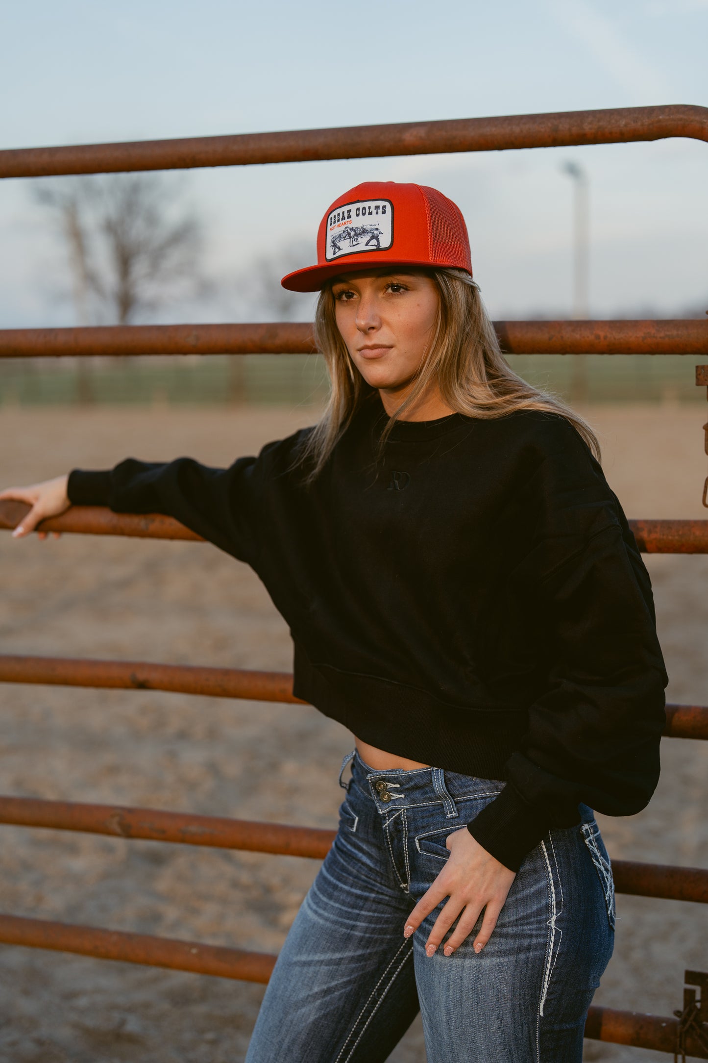 girl wearing cropped black western warmup hoodie Ranch Dress'n